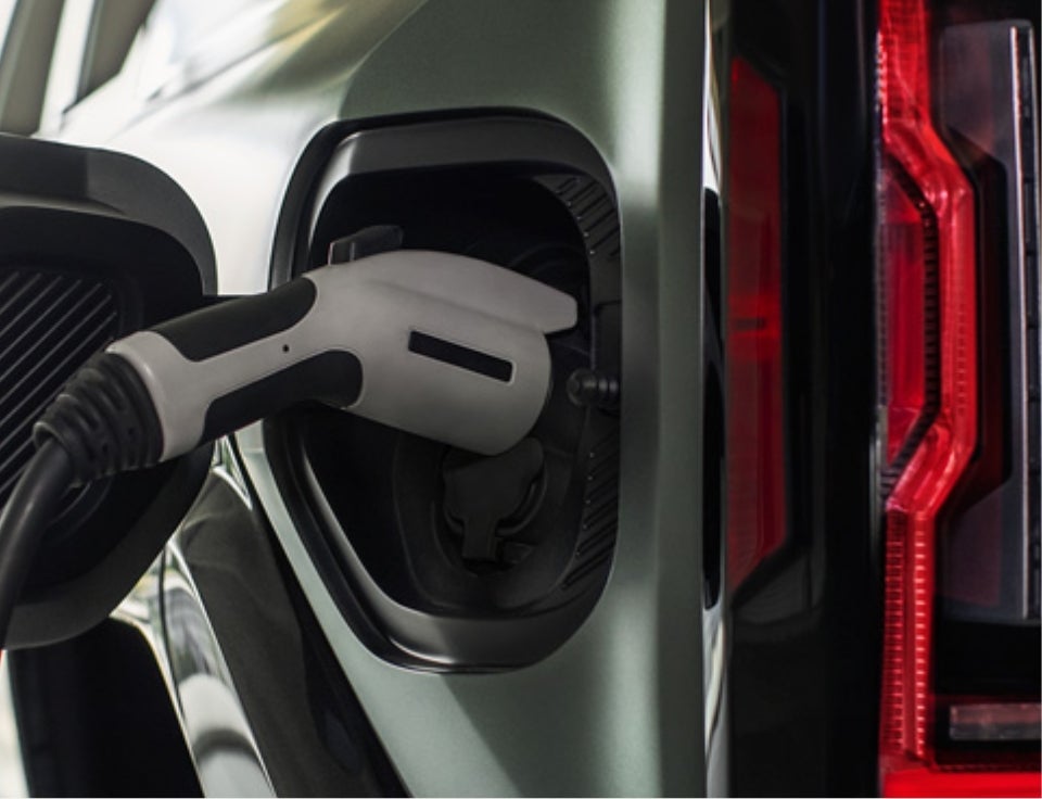 Close up of charging port with charger plugged in on a GMC Hummer EV SUV - Koons GMC Clarksville in CLARKSVILLE MD
